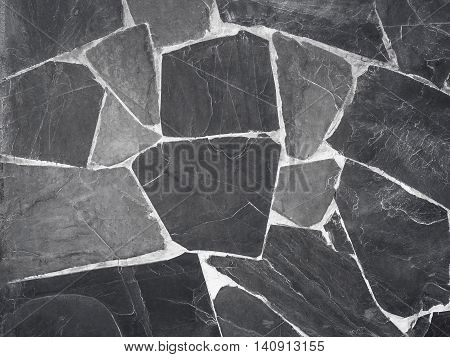 Black stone wall in resort. Nature background.