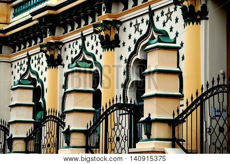 Singapore - December 17 2007: Saracen columns and iron gates enclose the ornate facade decorated with stars at the 1907 Masjid Abdul Gaffoor Mosque in Little India