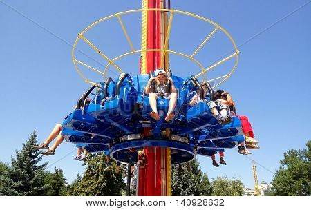 ALMATY KAZAKHSTAN - AUGUST 2 2016: The Fantasy Amusement park located in Almaty Kazakhstan. People ride and get the adrenaline.