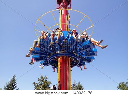 ALMATY KAZAKHSTAN - AUGUST 2 2016: The Fantasy Amusement park located in Almaty Kazakhstan. People ride and get the adrenaline.