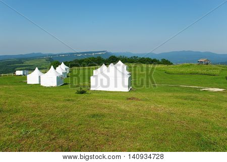 White tent on the green grass during the day