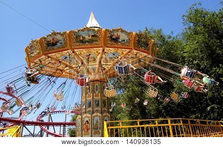 ALMATY KAZAKHSTAN - AUGUST 2 2016: The Fantasy Amusement park located in Almaty Kazakhstan. People ride and get the adrenaline.