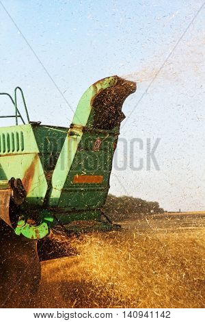 Combine harvester machine tractor in agriculture field.Back view taken closeup.