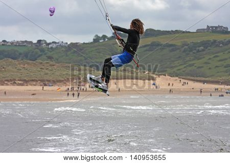 kitesurfer jumping off Bantham beach in Devon