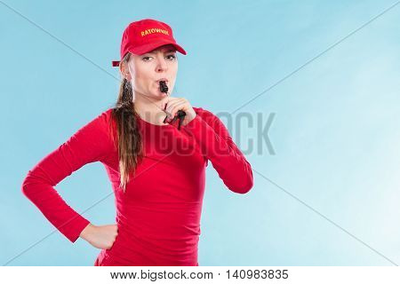Lifeguard Woman In Cap On Duty Blowing Whistle.