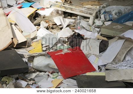 Wastepaper And Many Trash In An Abandoned Building With Many Garbage