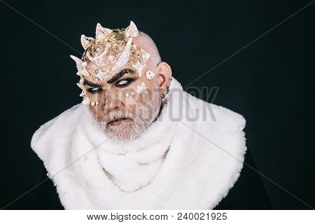 Demon On Black Background, Close Up. Man With Thorns Or Warts In Fur Coat. Alien, Demon, Sorcerer Ma