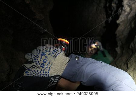 People Speleologists In The Cave Illuminate Their Way With Headlamps In Chortkiv/ukraine In April 20
