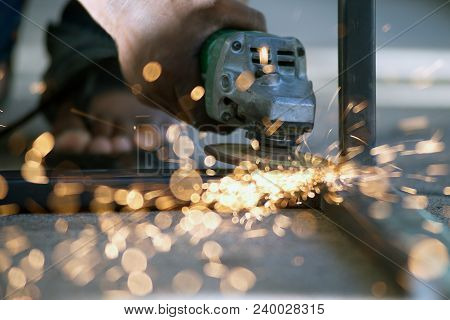The Worker Is Welding Metal Part Of Table Steel In Factory.