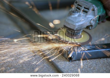 The Worker Is Welding Metal Part Of Table Steel In Factory.