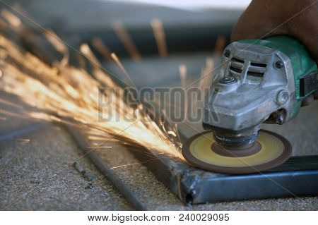 The Worker Is Welding Metal Part Of Table Steel In Factory.