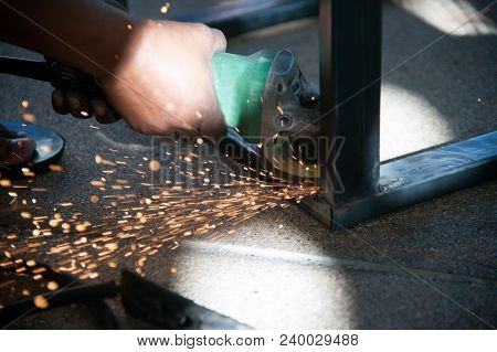 The Worker Is Welding Metal Part Of Table Steel In Factory.