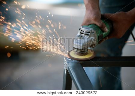 The Worker Is Welding Metal Part Of Table Steel In Factory.