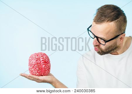 Adult Nerd Man Wearing Eyeglasses Looking At Human Brain Model. Thinking And Intelligence Conept