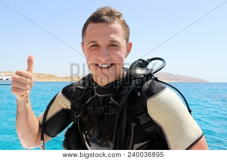 Happy Diver In A Suit For Diving Shows Trumb Up After Diving.