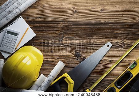 Construction And Renovation Concept. Building Contractor Tools On Wooden Table. Top View.