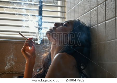 Smoking Concept. Sexy Women Are Smoking In The Room. Sexy Women Are Relaxing By Smoking. Beautiful W