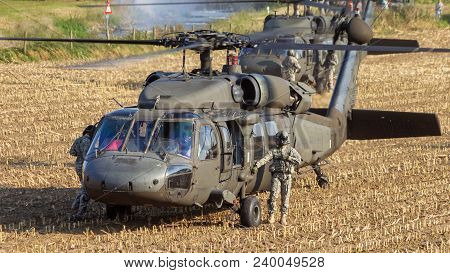 Grave, Netherlands - Sep 17, 2014: Two Us Army Blackhawk Helicopters About To Take Off From A Field