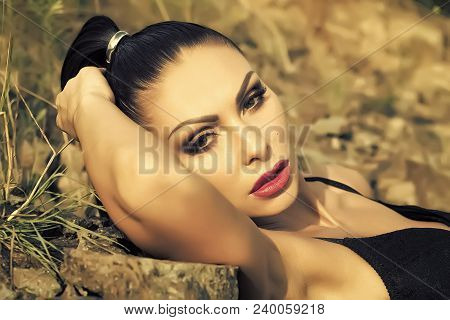 Closeup Photo Of Beautiful Sexy Brunette With Ponytail And Bright Makeup In Black Lingerie Lying On 