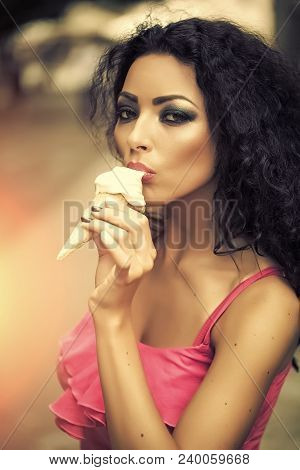 Sexual Brunette Pretty Young Lady With Bright Makeup Eating Cold Dessert Of Red Berry Ice Cream Cone