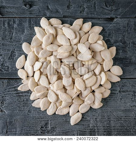A Bunch Of Pumpkin Seeds On A Dark Rustic Table. Vegetarian Cuisine. The View From The Top.