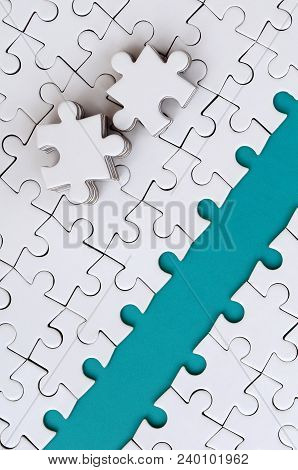The Blue Path Is Laid On The Platform Of A White Folded Jigsaw Puzzle. The Missing Elements Of The P