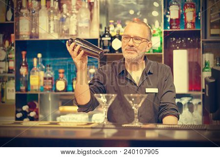 Professional Bartender Man Holding In Hands A Shaker With A Fresh Delicious Cocktail. Bartender Shak