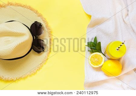 Straw Foman's Hat, Sun Glasses And Beach Accessory With Detox Citrics Water On Yellow. Top View. Fla