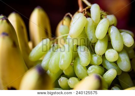 Close Up Fresh Green Grapes And Bananas. Healthy Food Concept