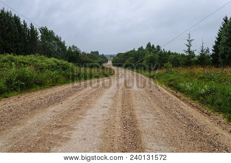 Country Macadam Road Trough The Forest, Cloudy Sky