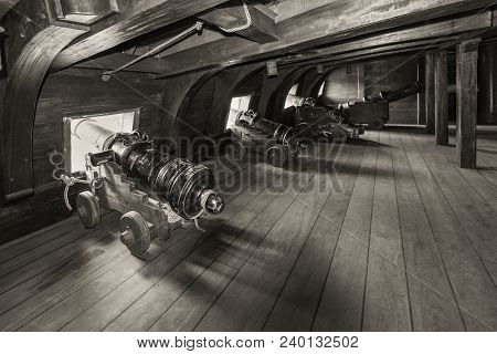 Genoa, Italy - May 14, 2017: Iron Cannons On The Gun Deck Of The Galleon Neptun Old Wooden Ship In P