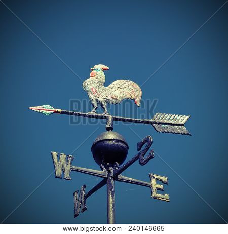 Metal Vane With A Rooster With Cardinal Points Indicating The Wind Direction