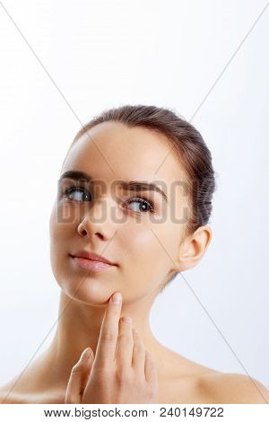 Beautiful Face Of Young Adult Woman With Clean Fresh Skin.