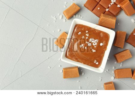 Gravy Boat With Salted Caramel Sauce And Candies On Table, Top View
