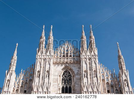 Some Spiers And Statues Of The Milan Cathedral With A Clear And Blue Sky