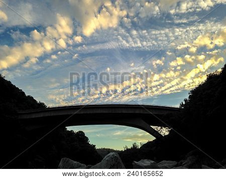 The Bridge On Highway 49 At The South Yuba River In Nevada County, Ca Is Silhouetted Against The Clo