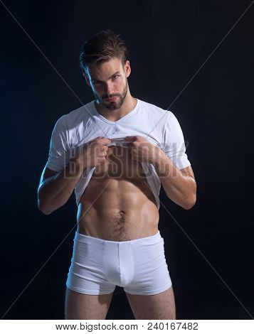 Bearded Man, Young Athletic Sexy Guy With Muscular Body And Torso In Underwear Undressing On Dark Ba