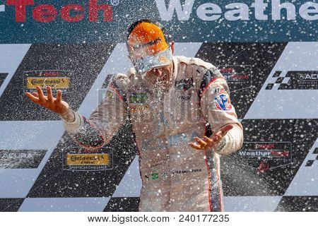 May 06, 2018 - Lexington, Ohio, USA: Hello Castroneves (BRA) is showered with champagne from his fellow racers after winning the Acura Sports Car Challenge at Mid Ohio in Lexington, Ohio.