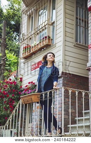 Istanbul, Turkey: Beautiful Girl Standing At Wooden House In Kuzguncuk District, On May 5, 2018