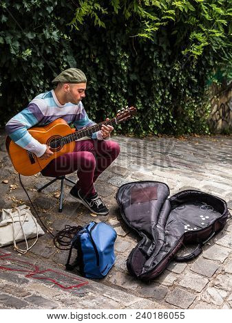 Paris, France - July 06, 2017: Street Musician Is Playing Guitar Outdoor At The Tertre Square (place