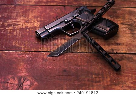 Butterfly Knife And Black Pistol.