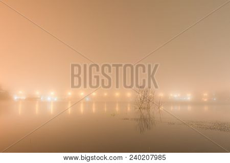 Abstact Blurred Background Of Uttamanusorn Bridge Or Mon Bridge With Light Reflection And Fog On Riv