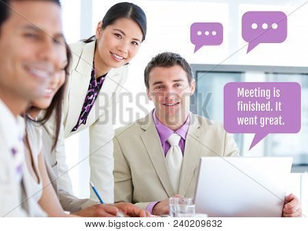 Business people at meeting on laptop with chat bubbles