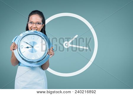 Woman holding a clock against background with clock
