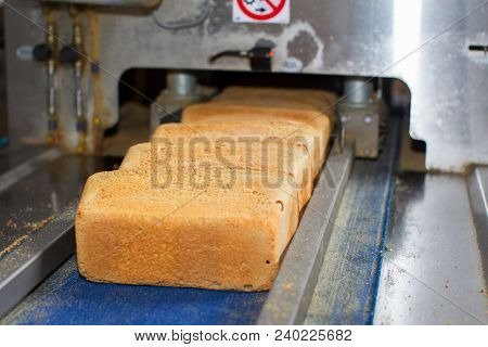 Industrial Bread Production Line.the Machine For Cutting And Packing Bread At The Factory