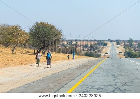 Poor People Walking On The Roadside In The Rural Caprivi Strip, The Most Populated Region In Namibia