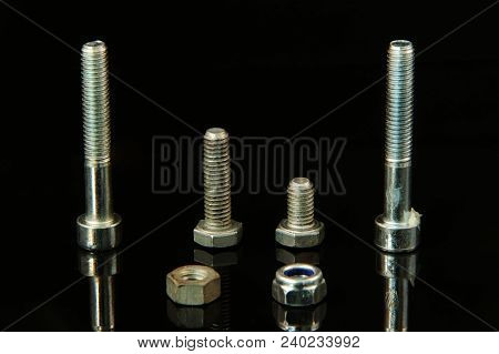 A Many Silver Screws In Curious Arrangement On Black Background