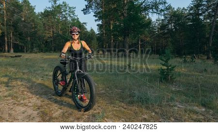 Fat Bike Also Called Fatbike Or Fat-tire Bike In Summer Riding In The Forest. Beautiful Girl And Her