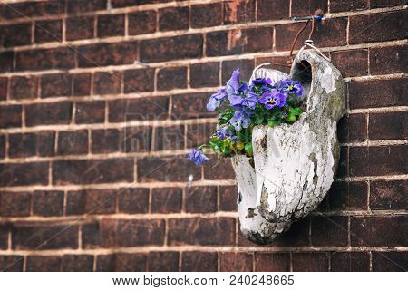 Wooden Klompen On Brick Wall Background