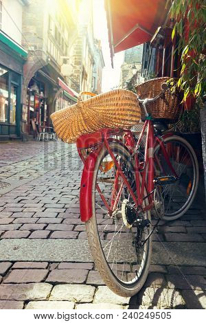 Red Retro Bicycle On The Beautiful Streets In The Famous City Of Dinan. Normandy, France